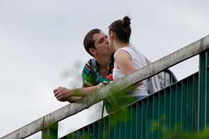 Young couple kissing on a bridge